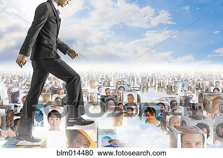 Stock Image - Korean businessman walking over images of business people. Fotosearch