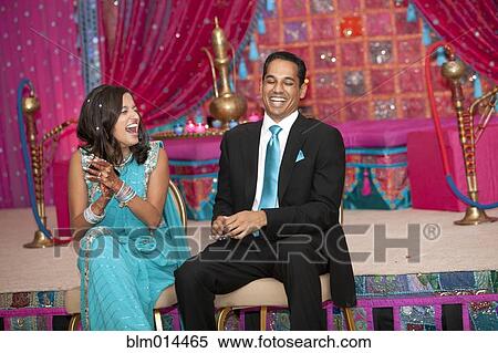 Stock Photography - Laughing Indian couple at wedding. Fotosearch