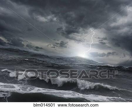 Stock Image - Lightning striking ocean water. Fotosearch
