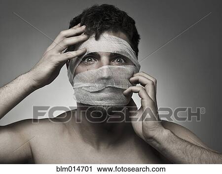 Stock Image - Man with bandages on his face. Fotosearch