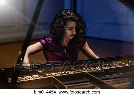 Middle Eastern woman playing piano View Large Photo Image Picture - Middle Eastern woman playing piano. Fotosearch