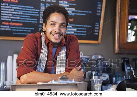 Mixed race man working in coffee shop View Large Photo Image Picture - Mixed race man working in coffee shop. Fotosearch