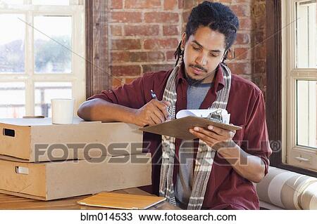 Mixed race man working in coffee shop View Large Photo Image Stock Image - Mixed race man working in coffee shop. Fotosearch