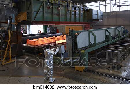 Stock Image - Worker near factory oven. Fotosearch