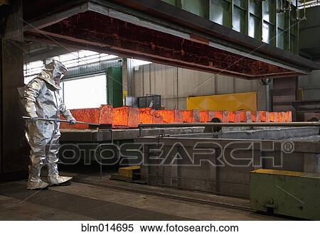 Worker working with hot metal in steel factory View Large Photo Image Stock Photography - Worker working with hot metal in steel factory. Fotosearch
