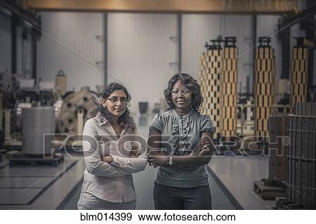 Workers standing together in factory View Large Photo Image Stock Photo - Workers standing together in factory. Fotosearch