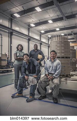 Stock Photo - Workers together in factory. Fotosearch