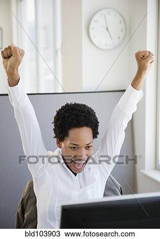 African American businesswoman sitting at desk cheering View Large Photo Image Stock Image - African American businesswoman sitting at desk cheering. Fotosearch