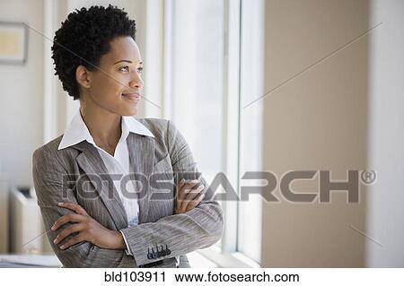 Stock Image - African American businesswoman with arms crossed. Fotosearch