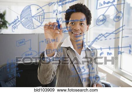 Stock Photo - African American businesswoman writing on glass board. Fotosearch