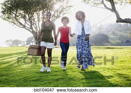 African American family walking in park View Large Photo Image Stock Photo - African American family walking in park. Fotosearch