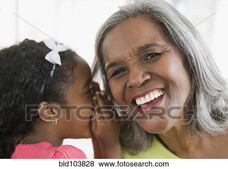 African American girl telling secret to grandmother View Large Photo Image Stock Photo - African American girl telling secret to grandmother. Fotosearch