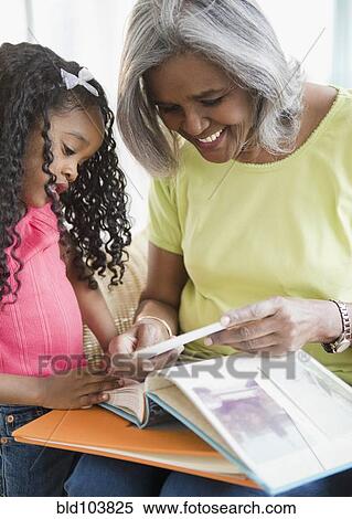 Stock Photography - African American grandmother and granddaughter reading a book. Fotosearch