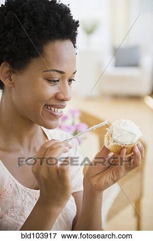 African American woman frosting cupcake View Large Photo Image Stock Photo - African American woman frosting cupcake. Fotosearch