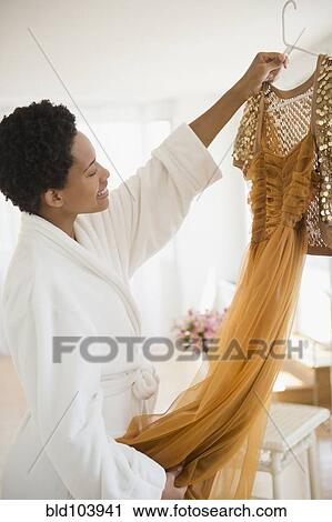 African American woman holding up glamorous dress View Large Photo Image Stock Image - African American woman holding up glamorous dress. Fotosearch