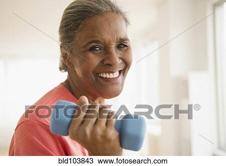 African American woman lifting dumbbells View Large Photo Image Stock Image - African American woman lifting dumbbells. Fotosearch