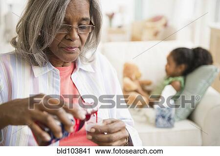 African American woman pouring cough syrup for granddaughter View Large Photo Image Stock Image - African American woman pouring cough syrup for granddaughter. Fotosearch