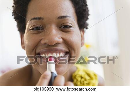 African American woman putting on lipstick View Large Photo Image Stock Image - African American woman putting on lipstick. Fotosearch