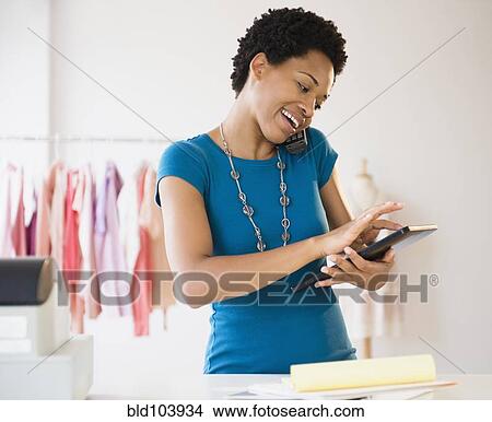 African American woman using a digital tablet at work View Large Photo Image Picture - African American woman using a digital tablet at work. Fotosearch