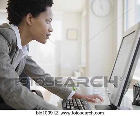 Stock Image - African American woman using computer. Fotosearch