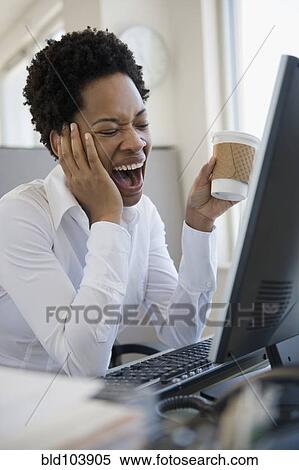 African American woman yawning at desk View Large Photo Image Stock Photography - African American woman yawning at desk. Fotosearch
