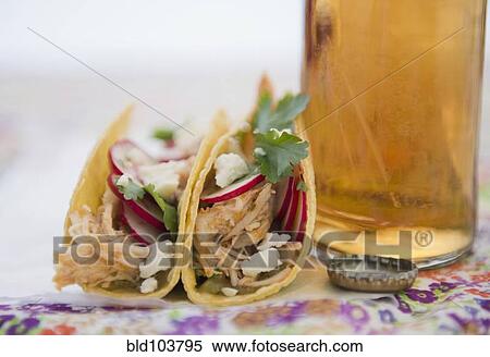 Stock Photography - Beer and Mexican chicken tacos. Fotosearch