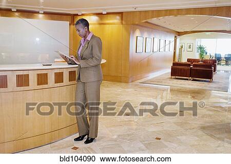 Stock Image - Black businesswoman using digital tablet in office. Fotosearch