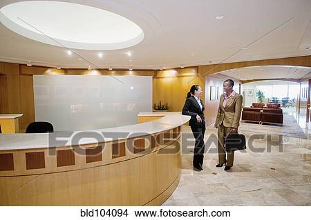 Picture - Businesswomen talking in office. Fotosearch
