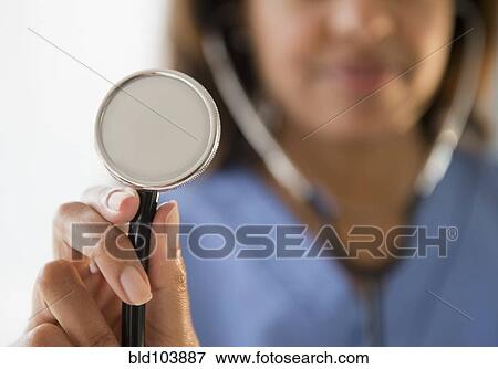 Stock Photo - Cape Verdean doctor holding stethoscope. Fotosearch