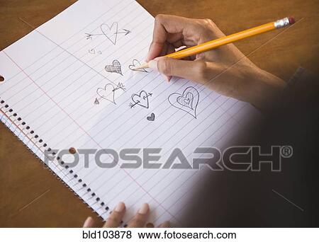 Stock Photo - Cape Verdean woman doodling hearts. Fotosearch