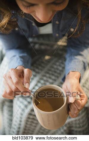 Stock Photo - Cape Verdean woman drinking coffee. Fotosearch