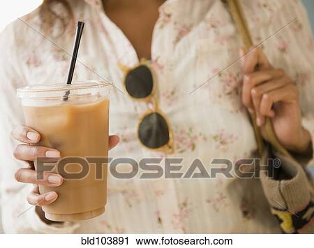 Cape Verdean woman drinking iced coffee View Large Photo Image Stock Image - Cape Verdean woman drinking iced coffee. Fotosearch