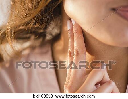 Stock Photo - Cape Verdean woman feeling her pulse. Fotosearch