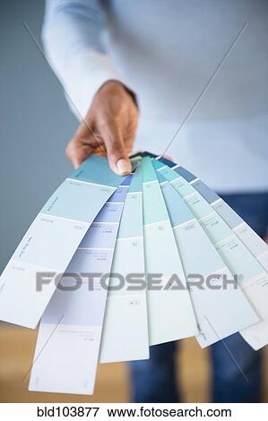 Stock Photo - Cape Verdean woman holding color swatches. Fotosearch