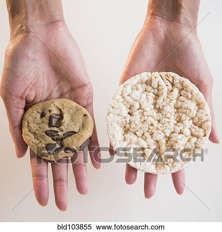 Stock Photography - Cape Verdean woman holding cookie and rice cake. Fotosearch