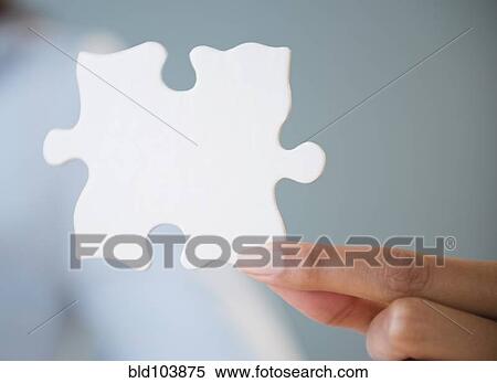 Stock Photography - Cape Verdean woman holding puzzle piece. Fotosearch