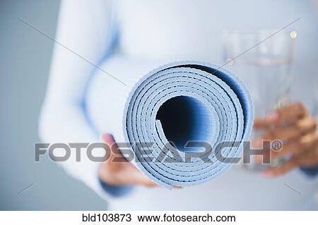 Cape Verdean woman holding yoga mat View Large Photo Image Stock Image - Cape Verdean woman holding yoga mat. Fotosearch