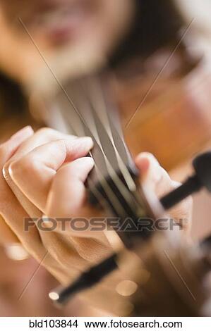 Picture - Cape Verdean woman playing the violin. Fotosearch