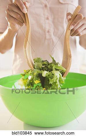 Stock Photography - Cape Verdean woman tossing a salad. Fotosearch