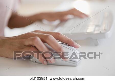 Stock Image - Cape Verdean woman using computer. Fotosearch