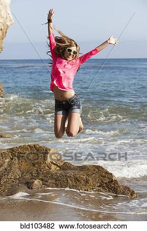 Caucasian teenager jumping on beach View Large Photo Image Stock Image - Caucasian teenager jumping on beach. Fotosearch