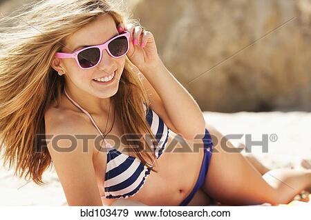 Stock Photo - Caucasian teenager laying on beach. Fotosearch