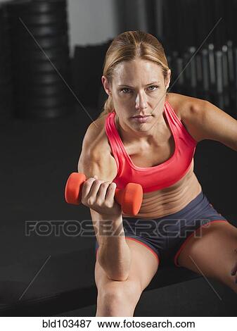 Caucasian woman using dumbbell View Large Photo Image Stock Photo - Caucasian woman using dumbbell. Fotosearch