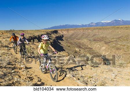 Family mountain biking near canyon View Large Photo Image Picture - Family mountain biking near canyon. Fotosearch