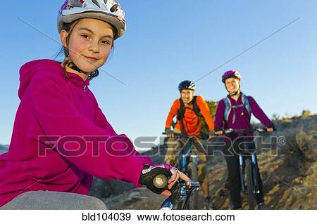 Stock Photo - Family mountain biking together. Fotosearch