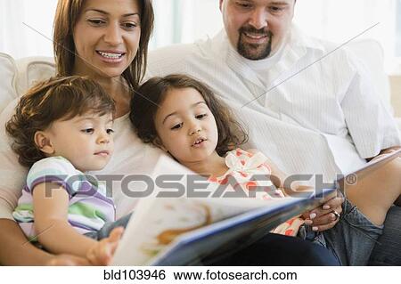 Stock Photograph - Family reading book together. Fotosearch