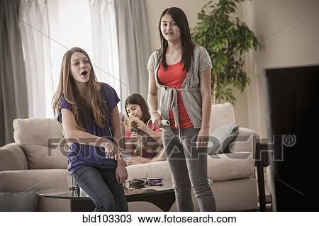 Friends playing video games together View Large Photo Image Stock Image - Friends playing video games together. Fotosearch
