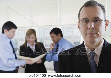 Stock Image - Hispanic business people working together. Fotosearch