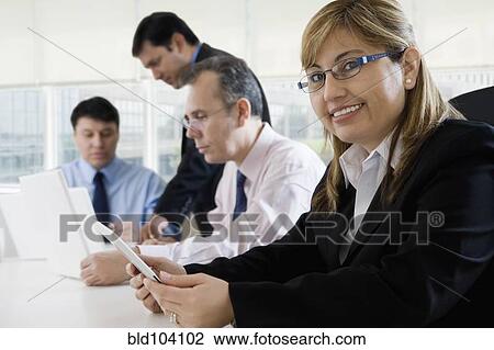 Stock Image - Hispanic business people working together. Fotosearch