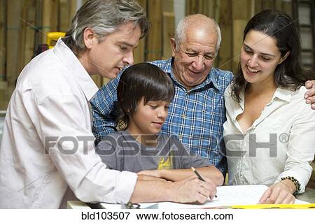 Stock Photo - Hispanic family in carpentry workshop. Fotosearch